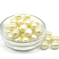 Vintage opaque cream pearlized plastic nugget beads measure approximately 12mm long and 10.5mm wide, with center-drilled 1.0mm lengthwise holes.