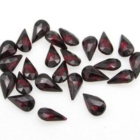 Vintage tin table cut pear shape rhinestones are translucent garnet red backed with gold foil. Point back stones measure 10mm long and 6mm wide.
