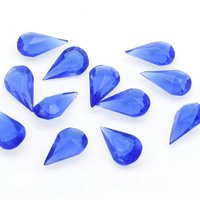 Vintage tin table cut pear shape rhinestones are translucent sapphire blue. Unfoiled point back stones measure 13mm long and 7.8mm wide.