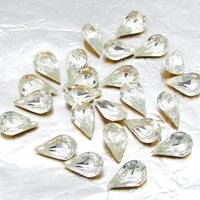 Vintage tin table cut pear shape rhinestones are clear crystal backed with gold foil. Point back stones measure 10mm long and 6mm wide.