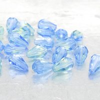 Small faceted teardrop beads are translucent two-tone peridot and sapphire blue Czech glass.