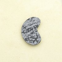 Flat underside of the kidney-shaped semiprecious gemstone cabochon.