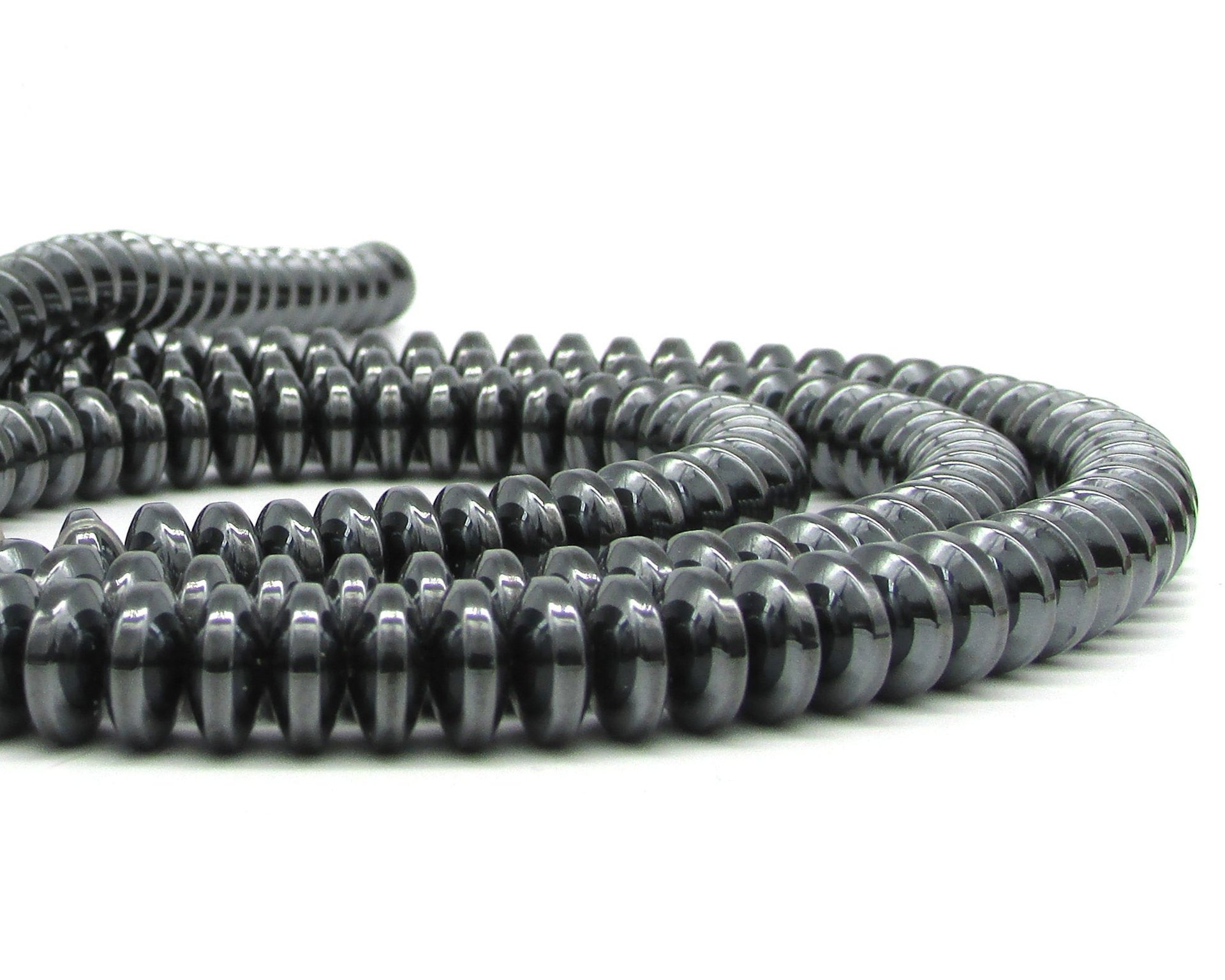 Shiny, non-magnetic hematite beads are convex rondelles measuring 9mm in diameter and 4mm thick with 0.8mm center holes.