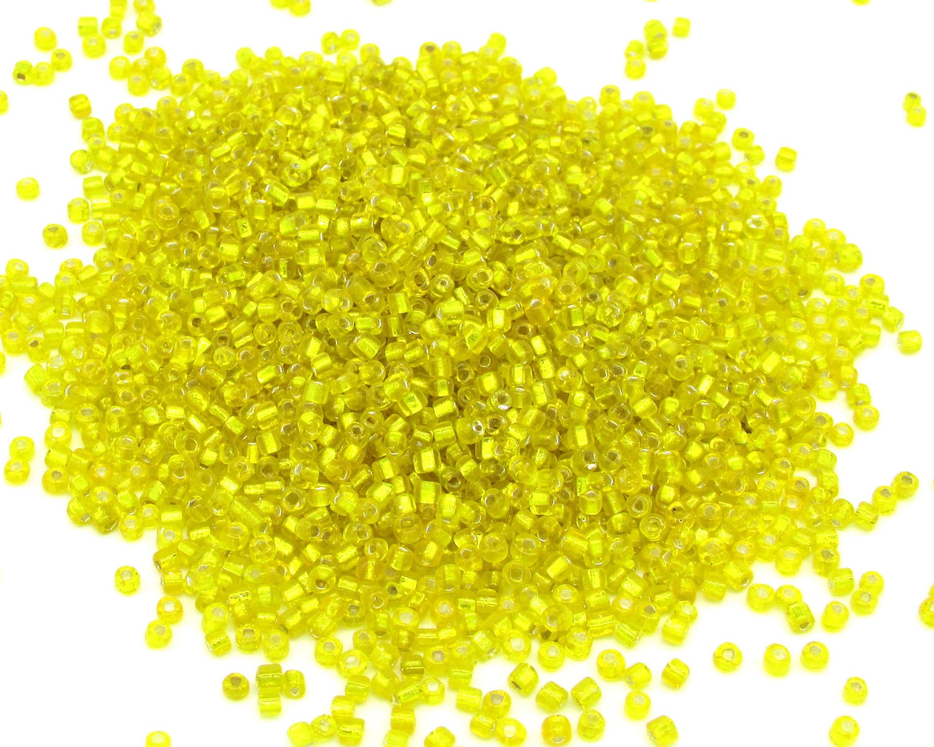 11/0 seed beads are translucent yellow glass with a silver foil lining. Tiny opaque rocailles average 2x2mm with round 0.64mm holes. 