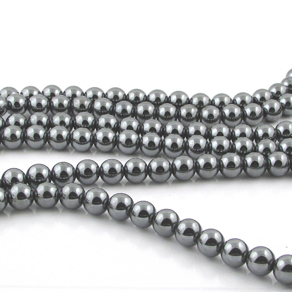 8mm round black beads are natural, non-magnetic hematite, polished to a mirror-like shine. Center-drilled holes measure 0.8mm holes. Each 16 inch strand has about 50 heavy gemstone beads and weighs approximately 2 ounces.