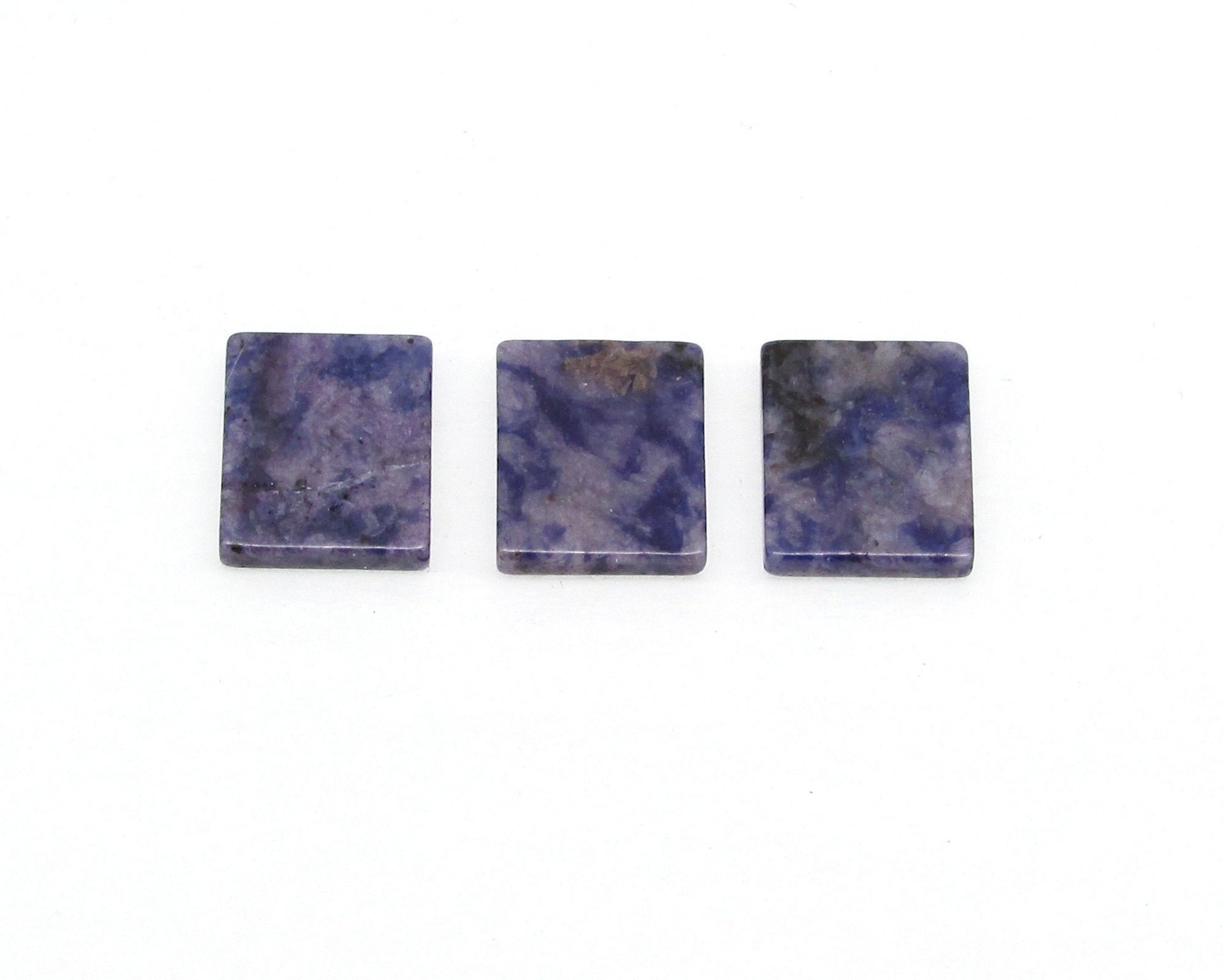Dark blue and gray sodalite flat rectangular cabochons measure approximately 12.25x10.25mm and are 2.25mm thick, with a single bevel along the girdle. 