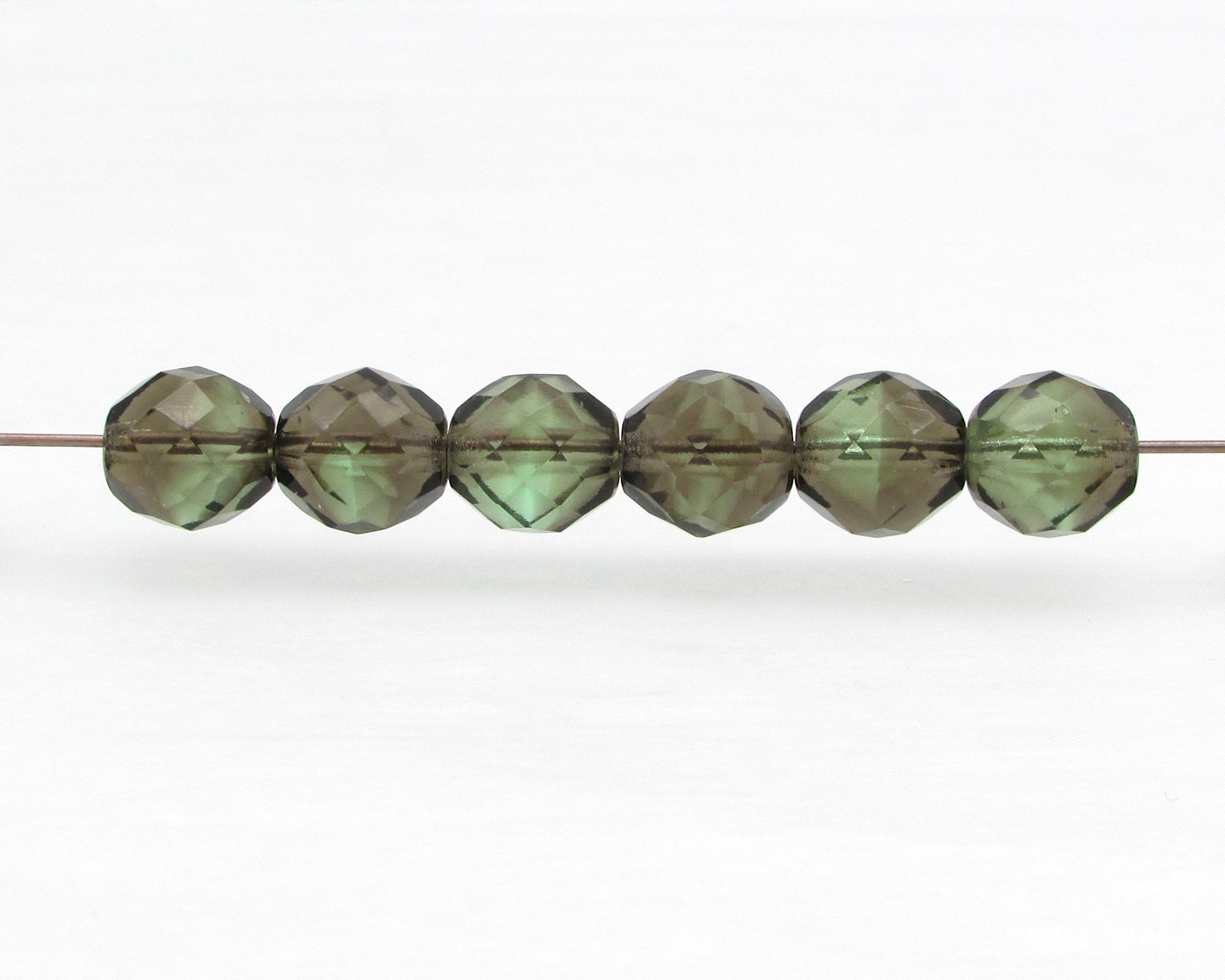 10mm round faceted glass beads are 2-tone translucent peridot green and earthy brown. Center drilled holes are approximately 1mm. 