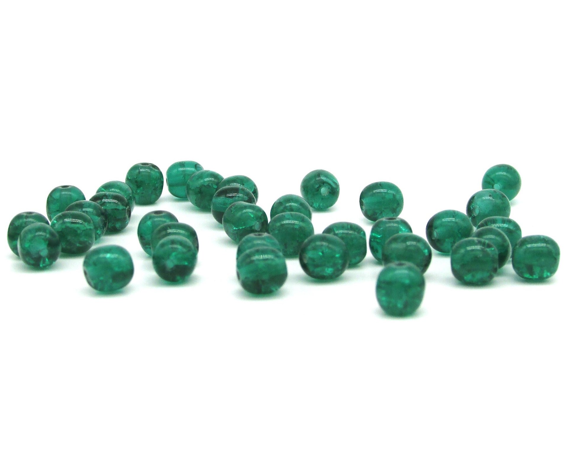 Round crackled glass beads measure 6mm in diameter with center-drilled 1mm holes. Available in several translucent colors.