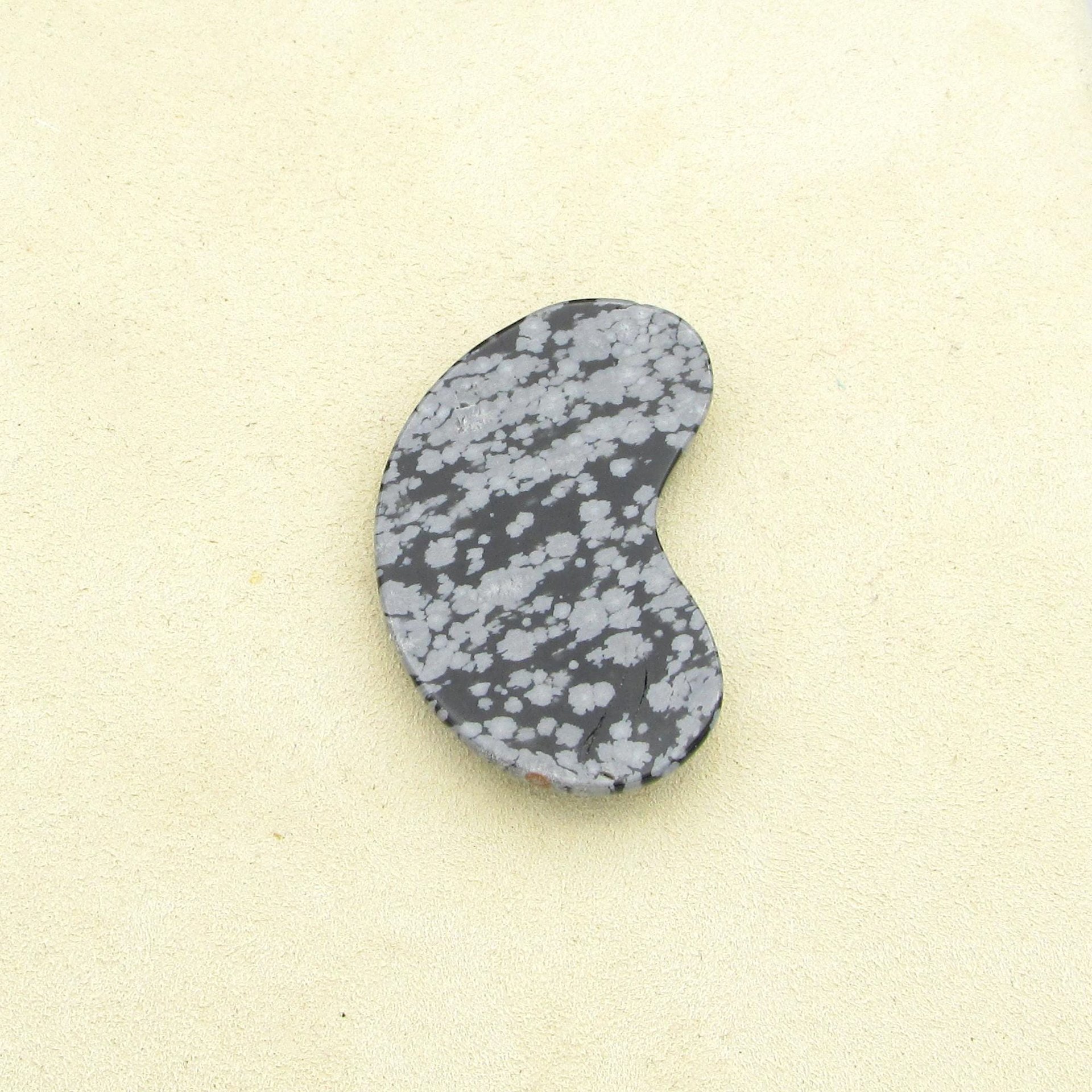 Flat underside of the kidney-shaped semiprecious gemstone cabochon.