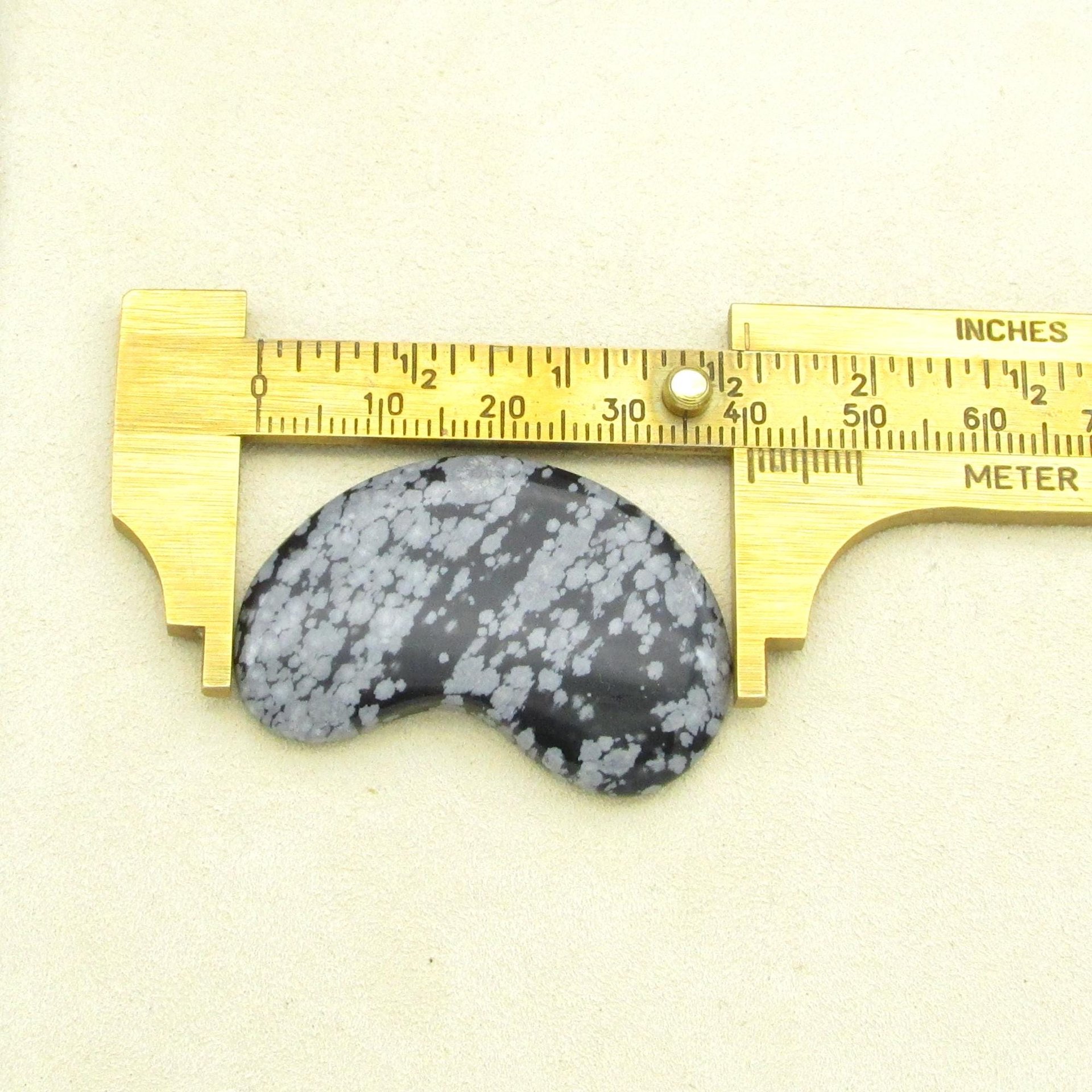 Length of the of the snowflake obsidian cabochon, as measured with a caliper.