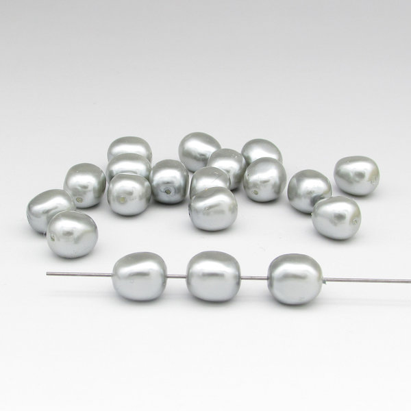 Vintage plastic pearls are a lustrous silver gray. These rectangular nuggets measure approximately 12mm long and 10mm wide, with 1mm center-drilled lengthwise holes.