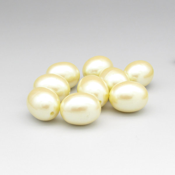 Vintage cream-colored plastic pearls are large oval beads measuring approximately 21.5mm long and 17mm wide. Lengthwise holes have a diameter of approximately 2mm,