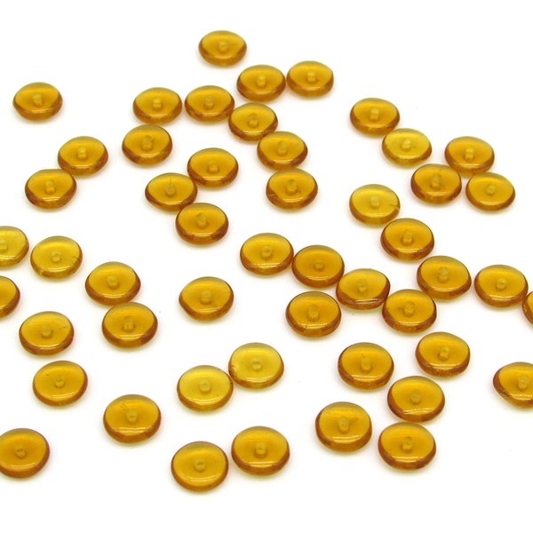 Translucent pressed glass rondelles are thin, round unfaceted disc beads measuring 7mm in diameter and 3mm thick with 1mm front-drilled holes. 50 piece lots are available in topaz, taupe, aqua, purple, and light green.