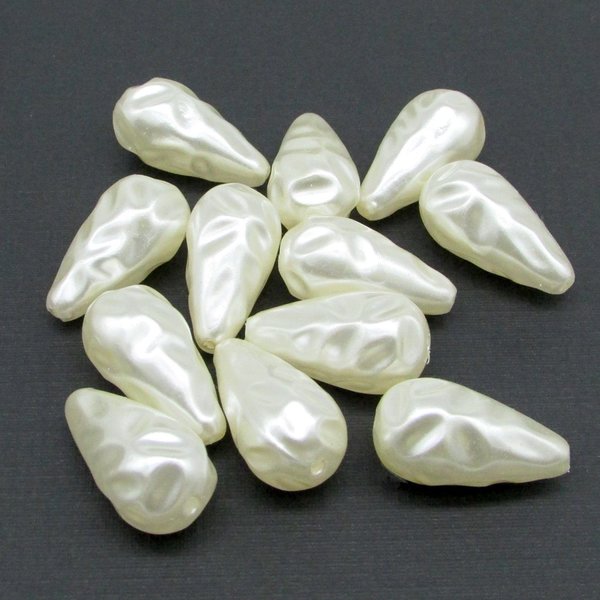 Vintage cream plastic pearl teardrops come in your choice of 22x11.5mm, 27x13.5mm, or 30x15.75mm sizes. The center-drilled lengthwise holes are approximately 1mm. These large droplets have a wrinkly baroque texture.