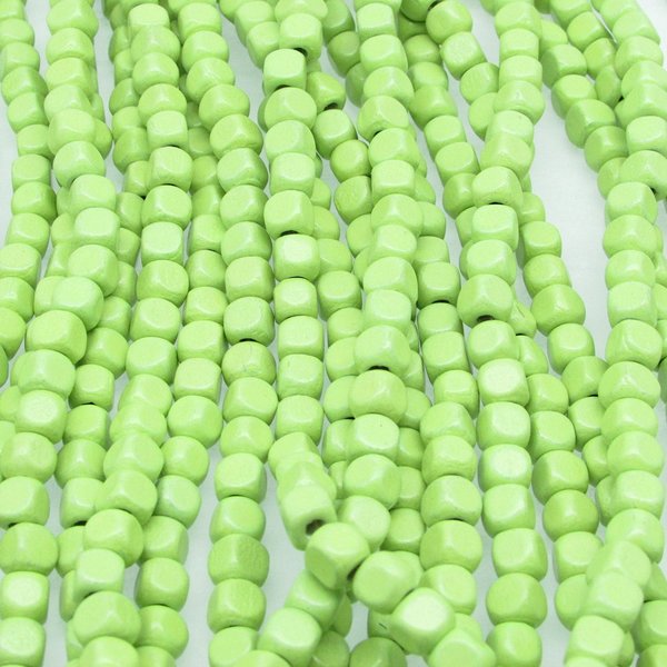 21 inch strand of vintage wooden beads has approximately 100 light green 5mm rounded cubes. 