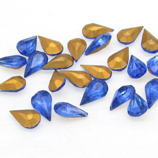 Faceted pear shape rhinestones are translucent sapphire blue with gold foil. Vintage tin table cut glass gems measure 10mm long and 6mm wide, with pointed backs. 