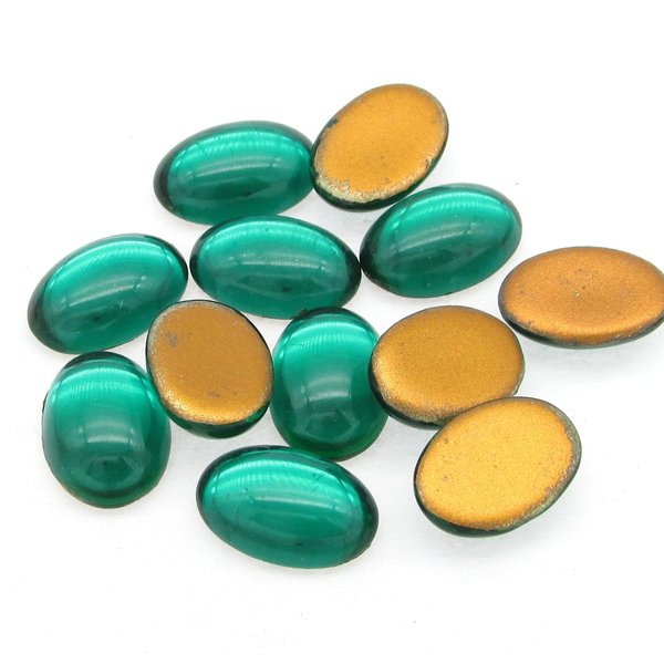 Vintage glass cabochons are translucent emerald green with gold foil. Flat back gems are 14mm long and 10mm wide, with a smooth 5mm dome. 