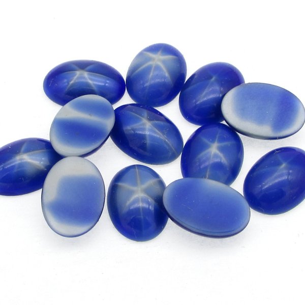Vintage glass cabochons are opaque dark blue with a paler star in the center. Unfoiled gems are 14mm long x 10mm wide with a 5mm smooth dome and a flat back.