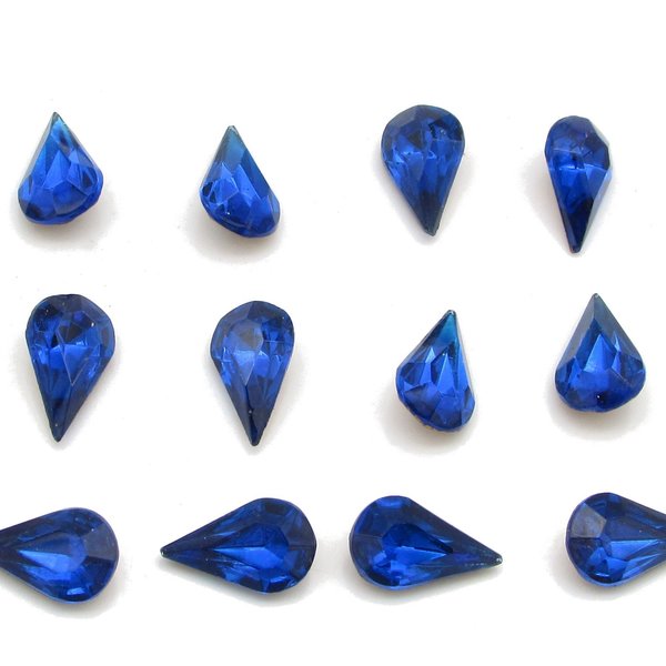 Vintage tin table cut pear shape rhinestones are translucent capri blue backed with gold foil. Point back stones measure 13mm long and 7.8mm wide.