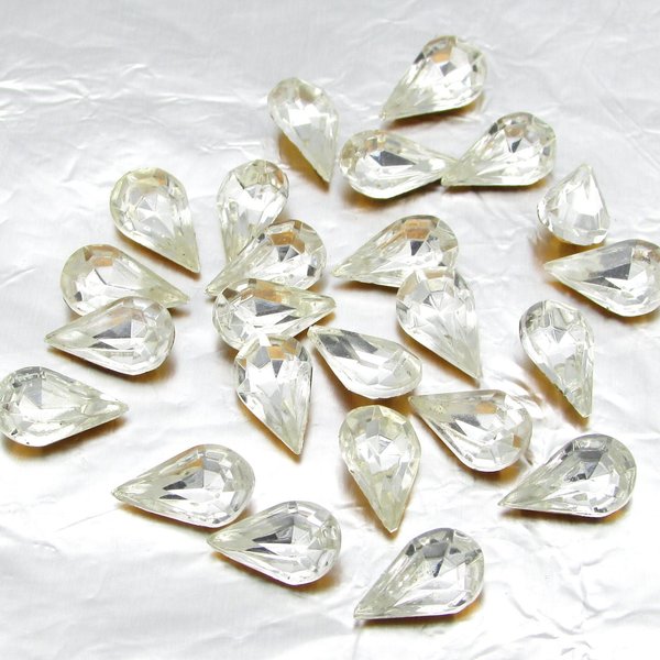 Vintage tin table cut pear shape rhinestones are clear crystal backed with gold foil. Point back stones measure 10mm long and 6mm wide.