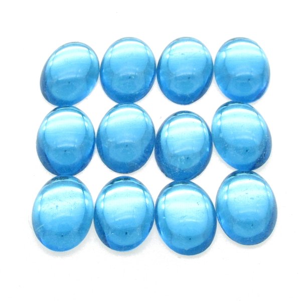 14x10mm vintage glass cabochons are translucent aquamarine blue. Smooth flat back gems have a 5mm dome and silver foiled backs.