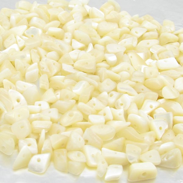 Lustrous, undyed mother of pearl chips are small freeform nuggets measuring approximately 5mm to 8mm long and 3mm to 5mm thick. Bead holes measure 0.8mm to 1.0mm in diameter.