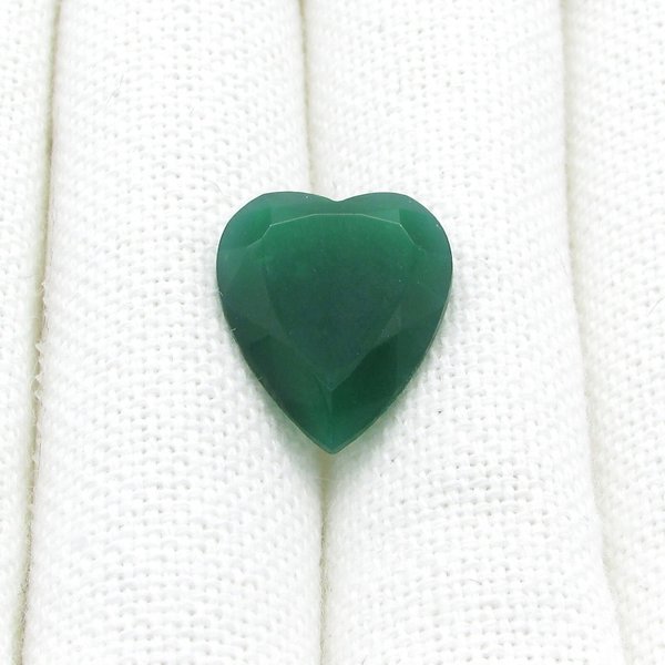 Semi-translucent jade green faceted glass heart measures 19mm long and 16mm wide.  Facets meet in a point a the back of the stone.  The back of the stone is unfoiled. 