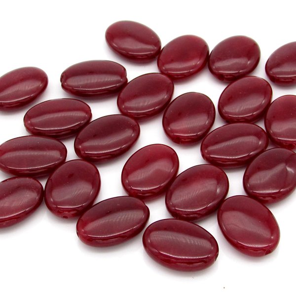Chalcedony beads have been been dyed shades of dark red. Bead are smooth ovals measuring approximately 18mm long, 13mm wide, and 5mm thick at the center. There's a shallow notch at each each end, where the 0.8mm diameter hole is positioned.