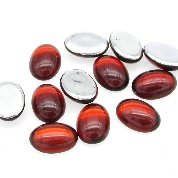 Vintage glass cabochons are translucent ruby red with bright silver foil and the back. Oval stones measure 14mm long by 10mm wide, with a smooth 5mm dome.