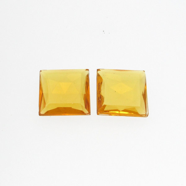Unfoiled topaz rhinestones are tin table cut glass stones with a faceted back and a flat top table with beveled edges. Stones measure approximately 14.5mm square and 5mm thick at the center. 