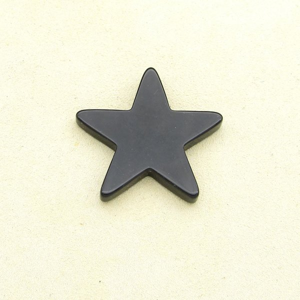 Vintage star shape cabochon is shiny, opaque black pressed glass measuring approximately 36.75mm across and 4.5mm thick.