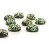 Oval glass cabochons measure 12mm long by 10mm wide, with flat backs and 6mm domes. Made by Cherry Brand artisans, these vintage foiled lampwork stones have an opaque black base with flecks of green, blue, gold and pink.